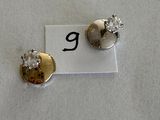 pair of diamond stud earrings on a white background with the letter g in the middle