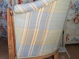 a chair that is sitting in a room with a wallpapered wall