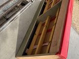 a red truck with a wooden crate in the back of it