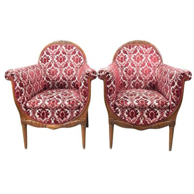 pair of red and white upholstered chairs on wooden legs