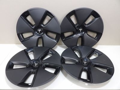 a set of four black wheel rims for a car