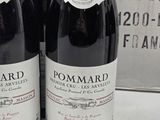 three bottles of wine sitting on a table in front of a box