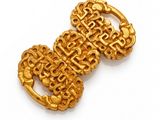 a close up of a gold buckle on a white surface