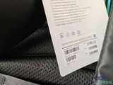 a label on the back of a black backpack