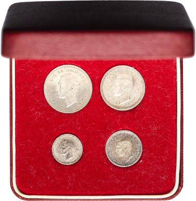 un gros plan sur une boîte rouge contenant trois pièces de monnaie