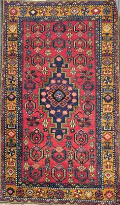 a red and blue rug with a design on it