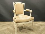 an image of a white chair with a beige upholstered seat