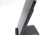 a cell phone that is sitting on top of a stand