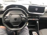 someone is sitting in the driver ' s seat of a car with their feet on the steering wheel