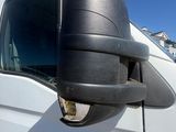 a white van with a black side view mirror on the side of it