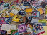 a pile of pokemon cards on the floor of a store