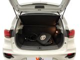 the trunk of a white car with a laptop in the trunk