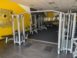 a gym with a lot of equipment in the room