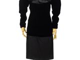 mannequin dressed in black dress with ruffled collar and black skirt