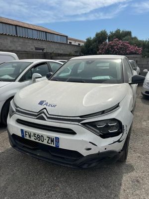 a white car parked in a parking lot next to other cars