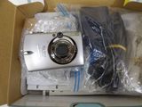 a white digital camera in a box on a table