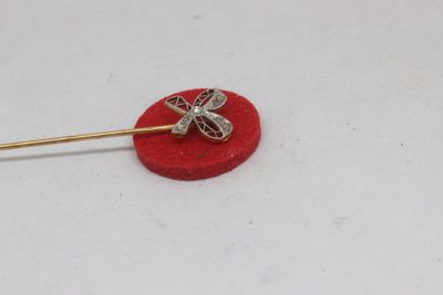 gold plated dragonfly brooch pin on a red velvet surface