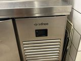 a stainless steel counter with a freezer underneath it