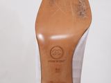 a close up of a pair of white shoes on a white surface