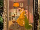 painting of a woman in a yellow dress sitting in a chair in front of a table with a lamp on it