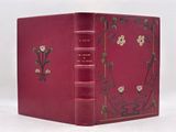 the book is red with gold trimmings and a decorative design