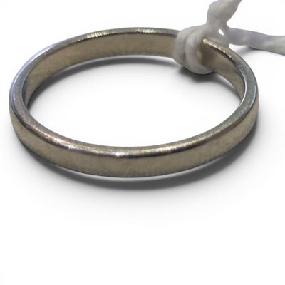 a silver ring with a knot on it on a white surface