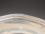 a silver bowl with a handle on a table