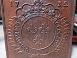 a close up of a wooden box with a design on it
