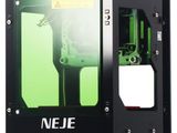 the 3d printer is sitting on a white surface with a green screen