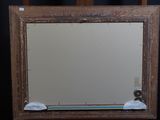 a mirror that is sitting on a wooden chair