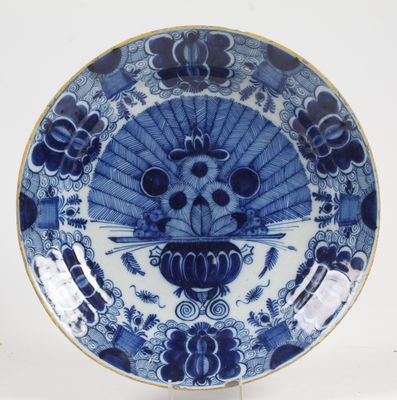 a blue and white plate with a skull on it