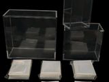 three clear plastic boxes with lids and napkins on a black background
