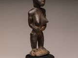 a bronze statue of a woman holding a baby on a black base