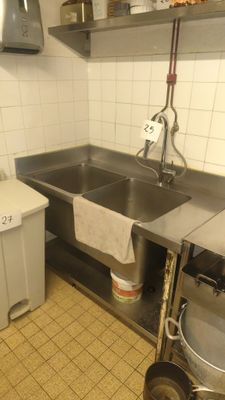 a kitchen with a sink, stove, and a dishwasher