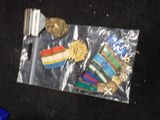 a bag of medals and a bottle of beer on the floor
