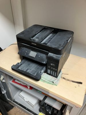 a printer sitting on top of a desk next to a printer