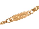 a close up of a gold chain with a tag on it