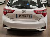 a white toyota yaris parked in a parking lot