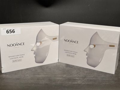 two boxes of noorance on a table with a clock in the background