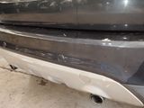 a close up of a car ' s rear bumper and exhaust pipe