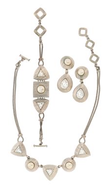 necklace, bracelet, and earrings set in silver with white stones