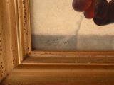 a painting of a bunch of cherries in a gold frame
