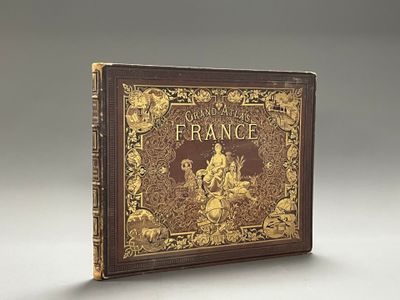 un vieux livre à la couverture dorée et noire posé sur une table