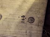 a close up of a clock on a wooden table