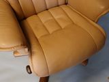 a tan leather recliner chair and ottoman in a living room