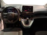 the interior of a small car with a steering wheel and dashboard