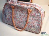 a bag that is sitting on a table next to a laptop