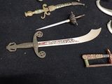 a lot of different types of knives on a table