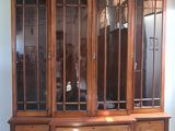 an image of a wooden entertainment center with glass doors