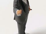 a figurine of a man in a tuxedo holding a baseball bat